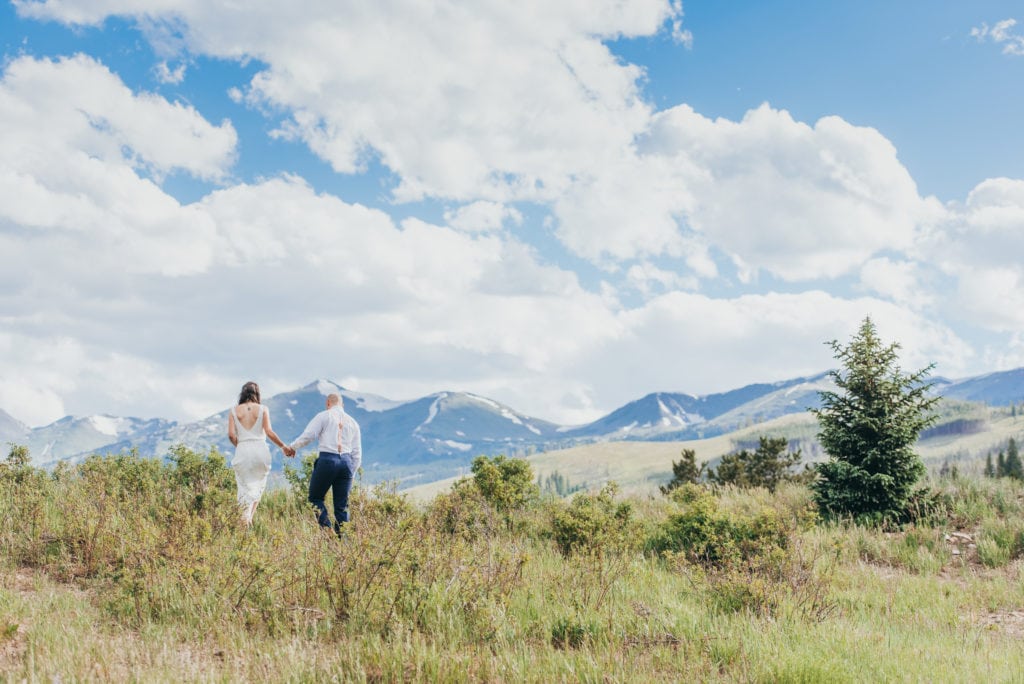 Adventurous couple hikes on their wedding day with views of Breckenridge, Colorado mountains