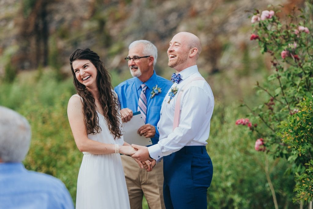 Happy couple laughs as they say their vows at their Breckenrdige, Colorado wedding