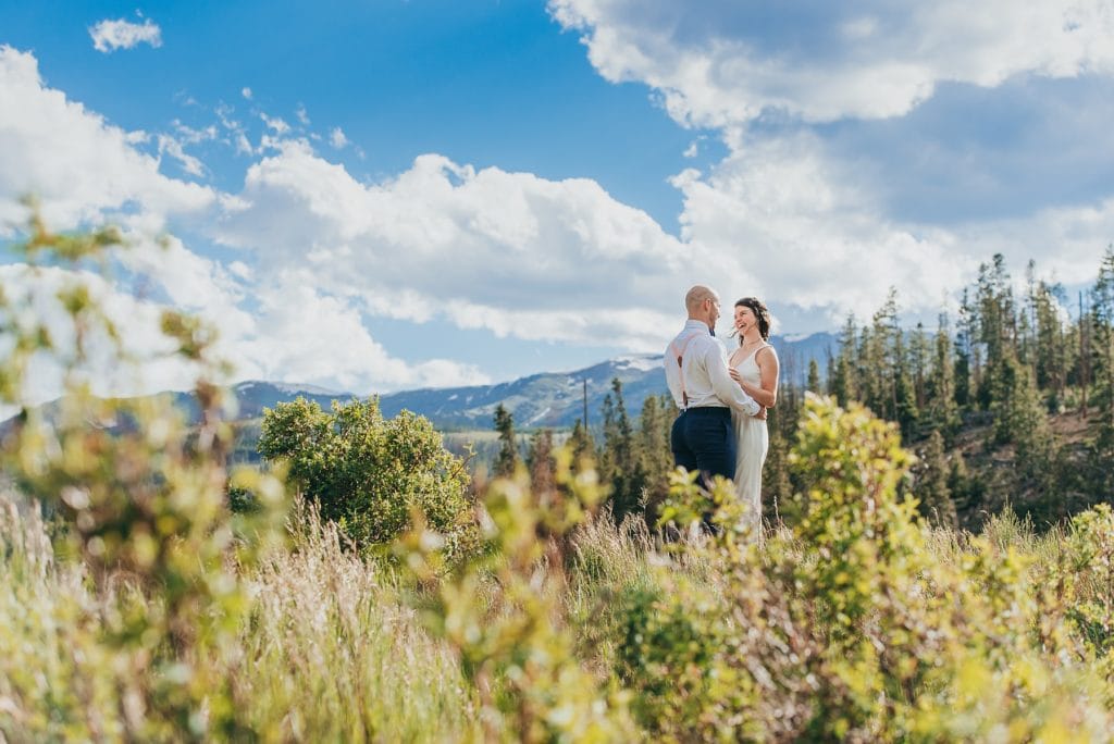 Adventure wedding couple laughs as they explore the mountains of Breckenridge, Colorado