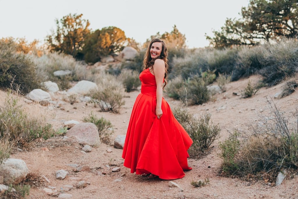 Bride wearing red strapless wedding dress for desert elopement