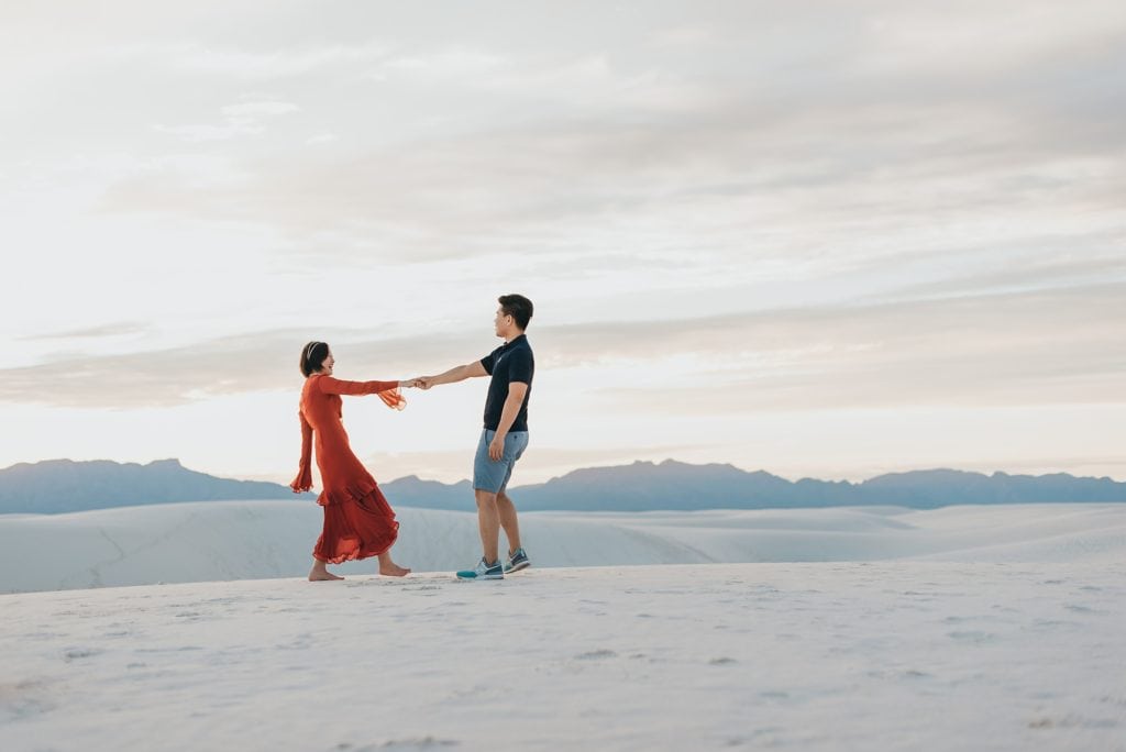 Couple plays on the dunes at White Sands for their engagement session