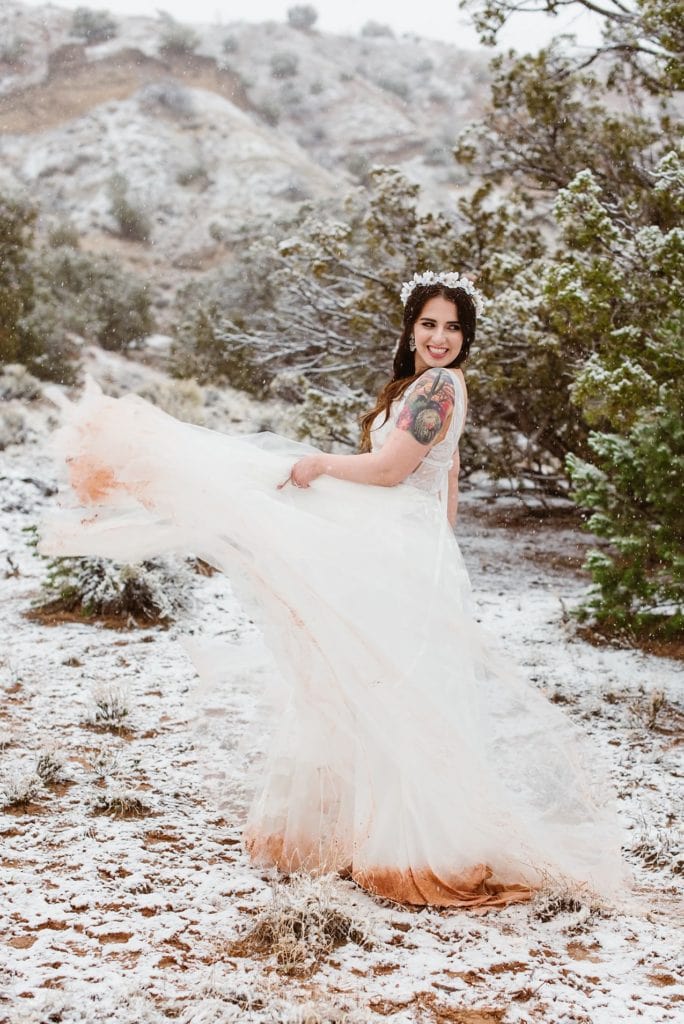 Adventurous bride shows off her red rock stained elopement dress