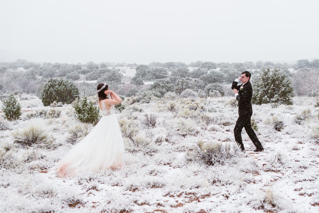 Bride and groom have a snowball fight on their elopement day